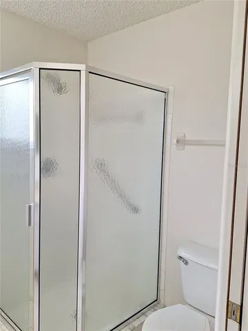 a bathroom with a glass shower door
