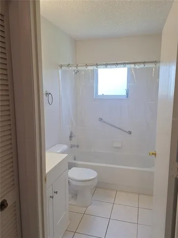 a bathroom with a granite countertop sink a toilet and shower