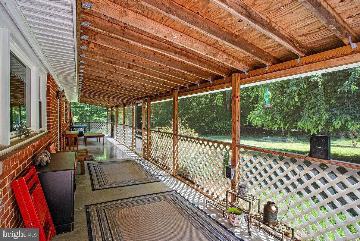 6600 Ashland Road La Plata, MD 20646 - Photo 27 of 40 a view of a patio with table and chairs and wooden floor