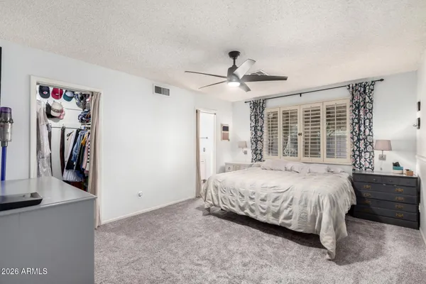 a bedroom with a bed closet and a large window