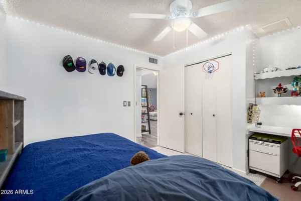 a bedroom with a bed and a view of kitchen