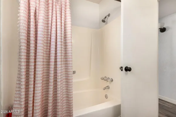 a bathroom with a bathtub and shower