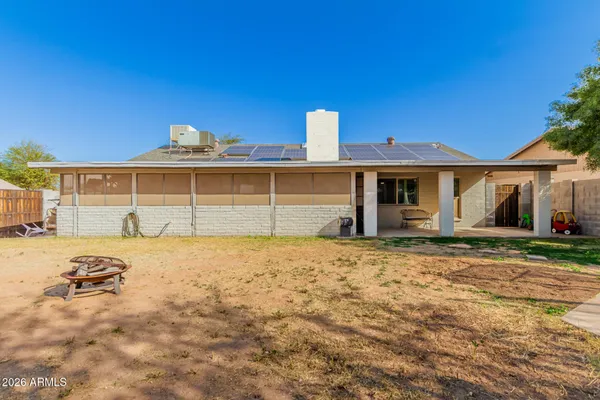 a view of a house with a wooden fence