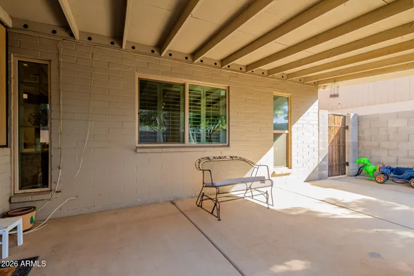 a view of a patio with table and chairs and wooden floor
