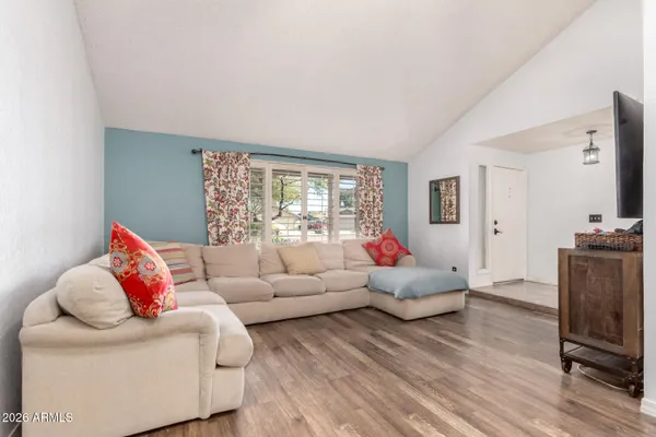 a living room with furniture window and wooden floor