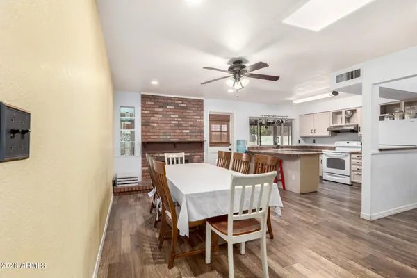 a view of a dining room with furniture and a kitchen