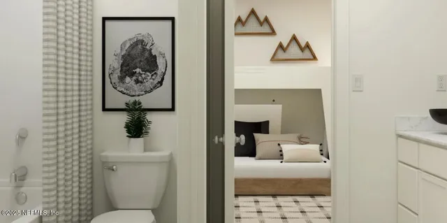 a bathroom with a toilet sink and mirror