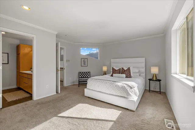 a spacious bedroom with a bed and a window