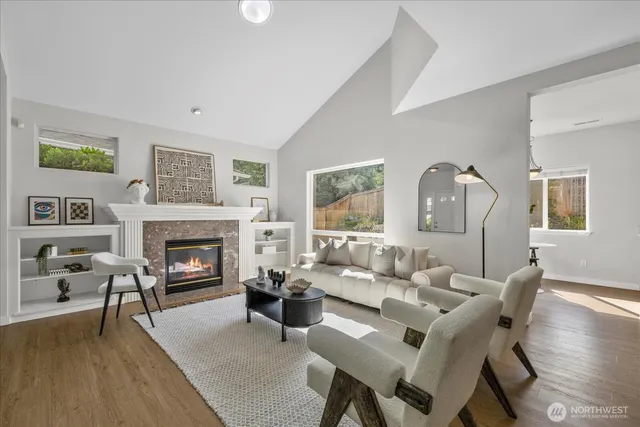 a living room with furniture a fireplace and a table