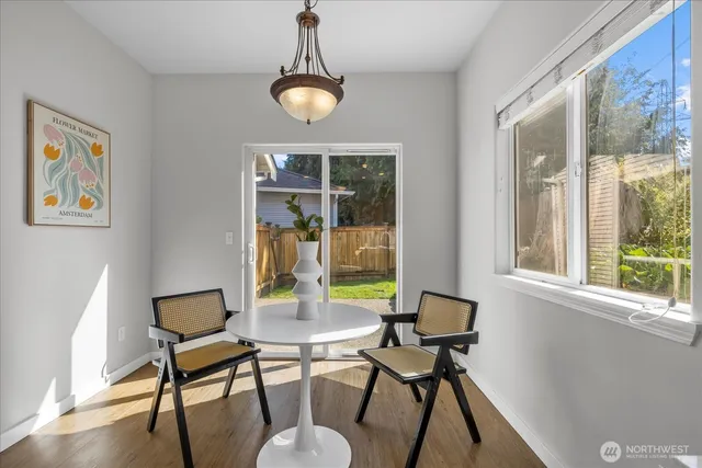 a view of a dining room with furniture window and wooden floor