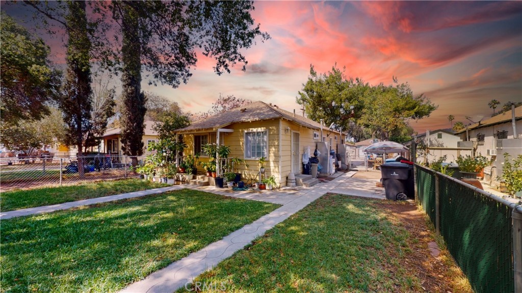 4155 Dwight Avenue Riverside, CA 92507 - Photo 1 of 1 a view of a patio with table and chairs under an umbrella