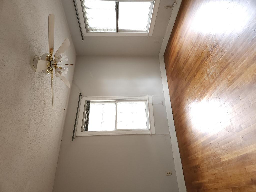 910 East 13th Street Austin, TX 78702 - Photo 11 of 16 a view of an empty room with wooden floor and a window