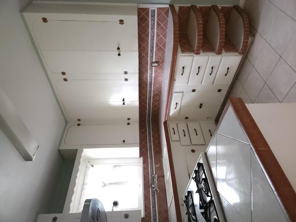 910 East 13th Street Austin, TX 78702 - Photo 12 of 16 a kitchen with white cabinets and appliances