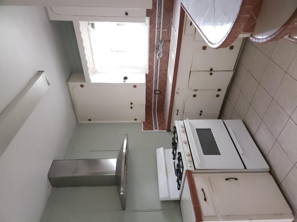910 East 13th Street Austin, TX 78702 - Photo 13 of 16 a kitchen with granite countertop a stove sink and cabinets
