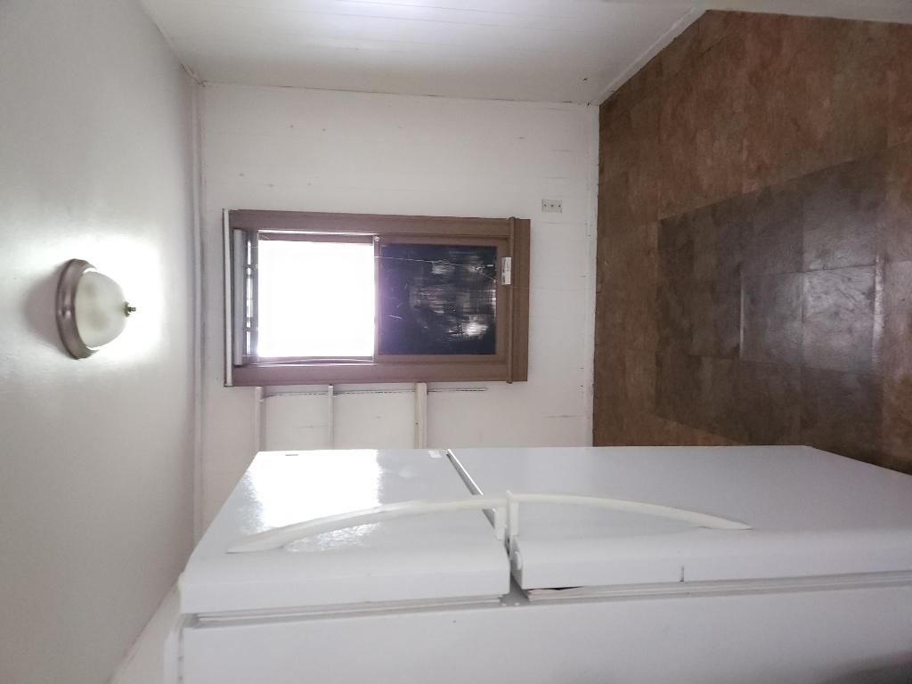 910 East 13th Street Austin, TX 78702 - Photo 14 of 16 an empty room with windows cabinet and door