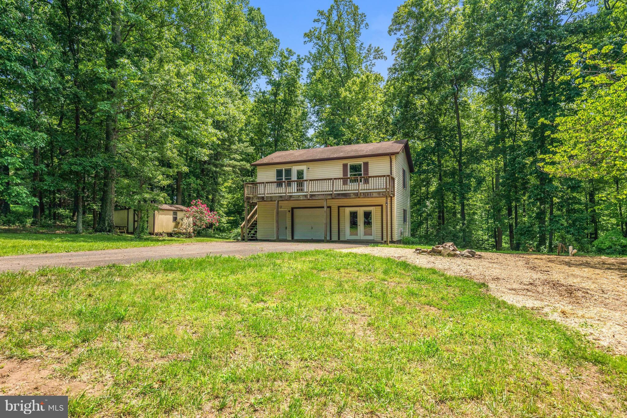11320 Drogheda Mountain Road Rixeyville, VA 22737 - Photo 1 of 29 a view of a house with a yard and large trees