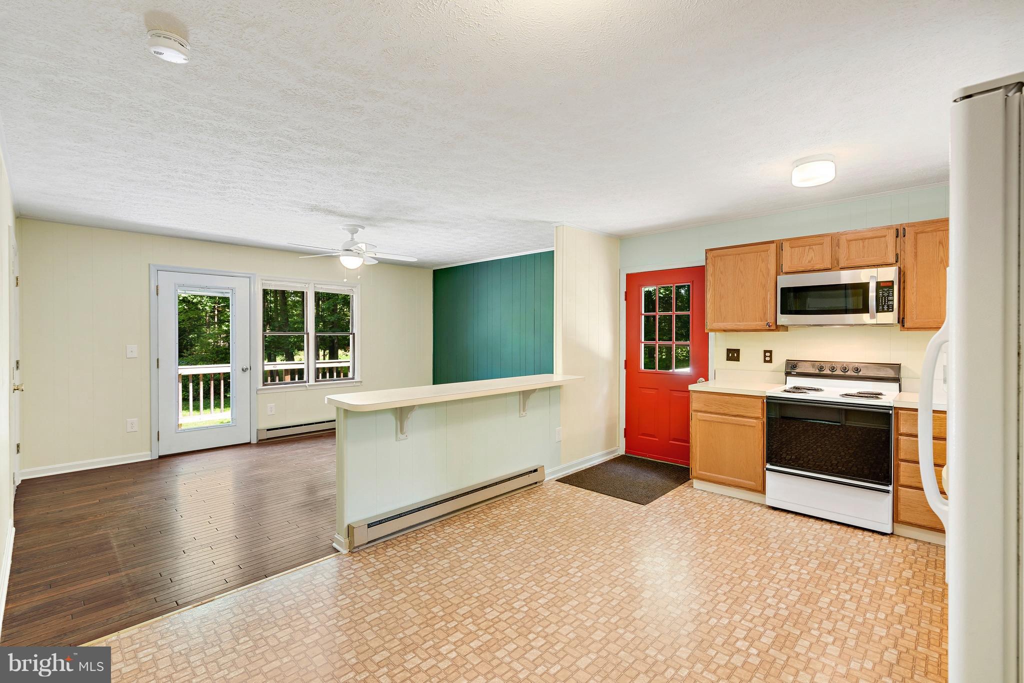 11320 Drogheda Mountain Road Rixeyville, VA 22737 - Photo 2 of 29 a large kitchen with stainless steel appliances granite countertop a stove and a sink