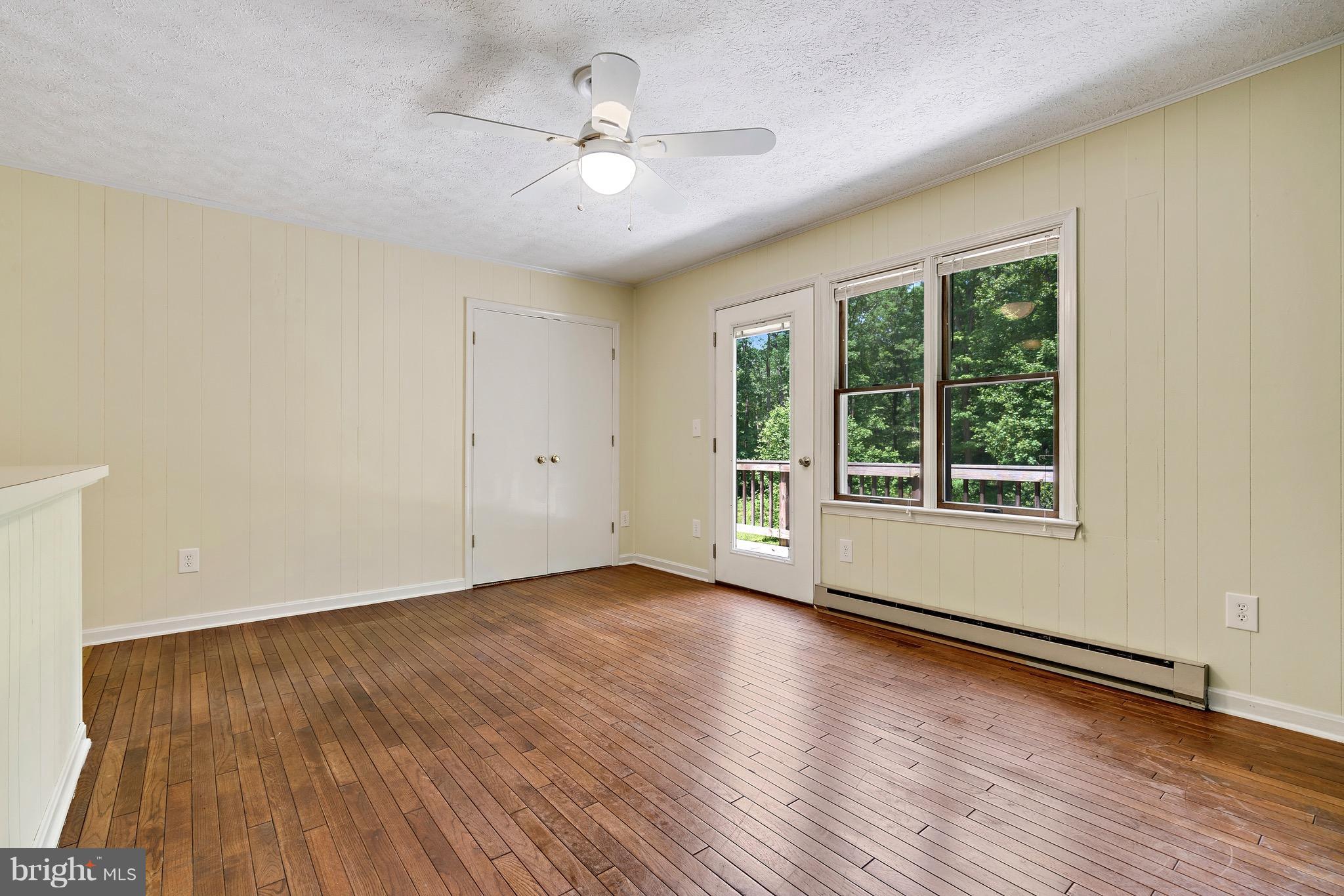 11320 Drogheda Mountain Road Rixeyville, VA 22737 - Photo 11 of 29 a view of an empty room with wooden floor and a window
