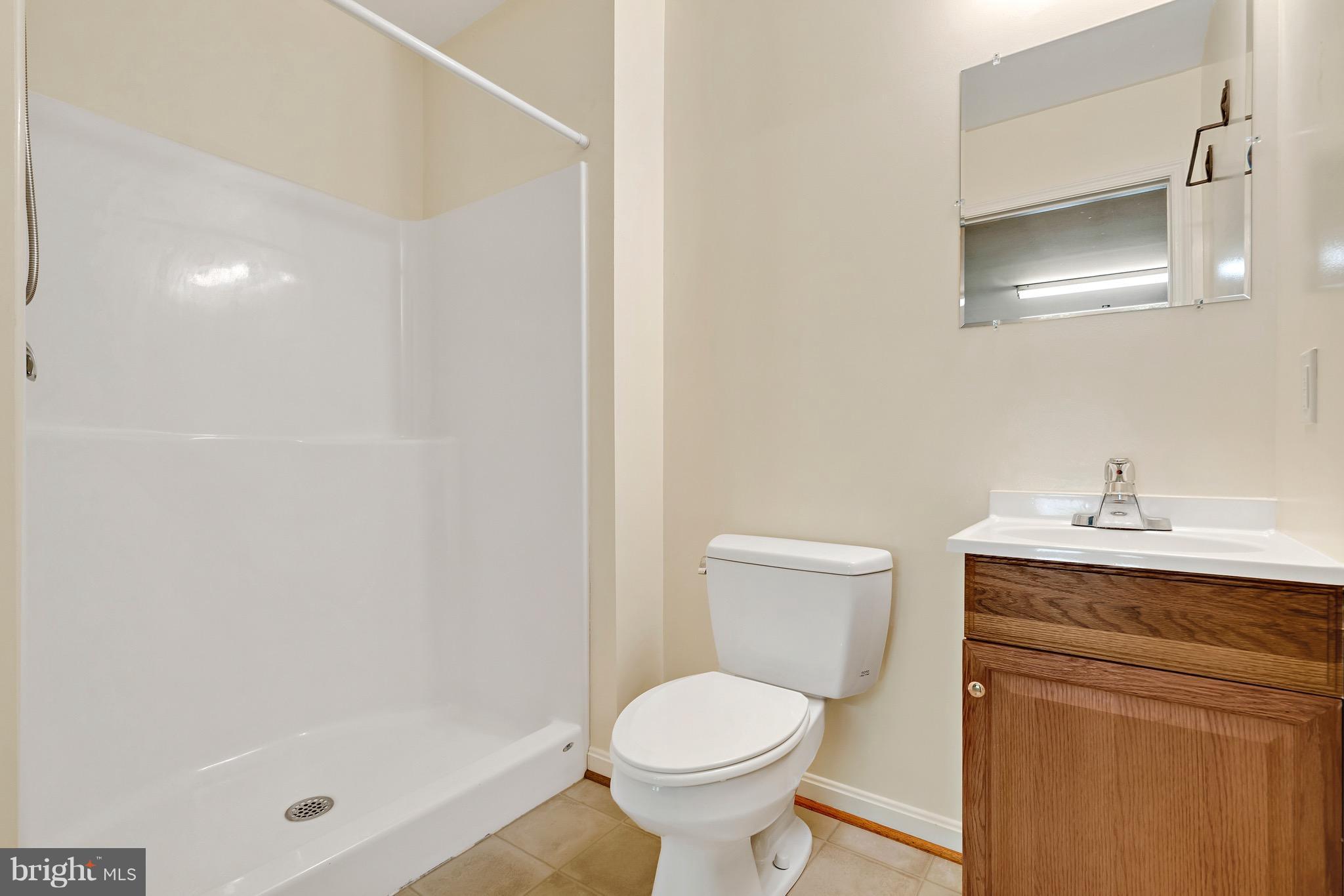 11320 Drogheda Mountain Road Rixeyville, VA 22737 - Photo 16 of 29 a white toilet sitting next to a bathroom sink