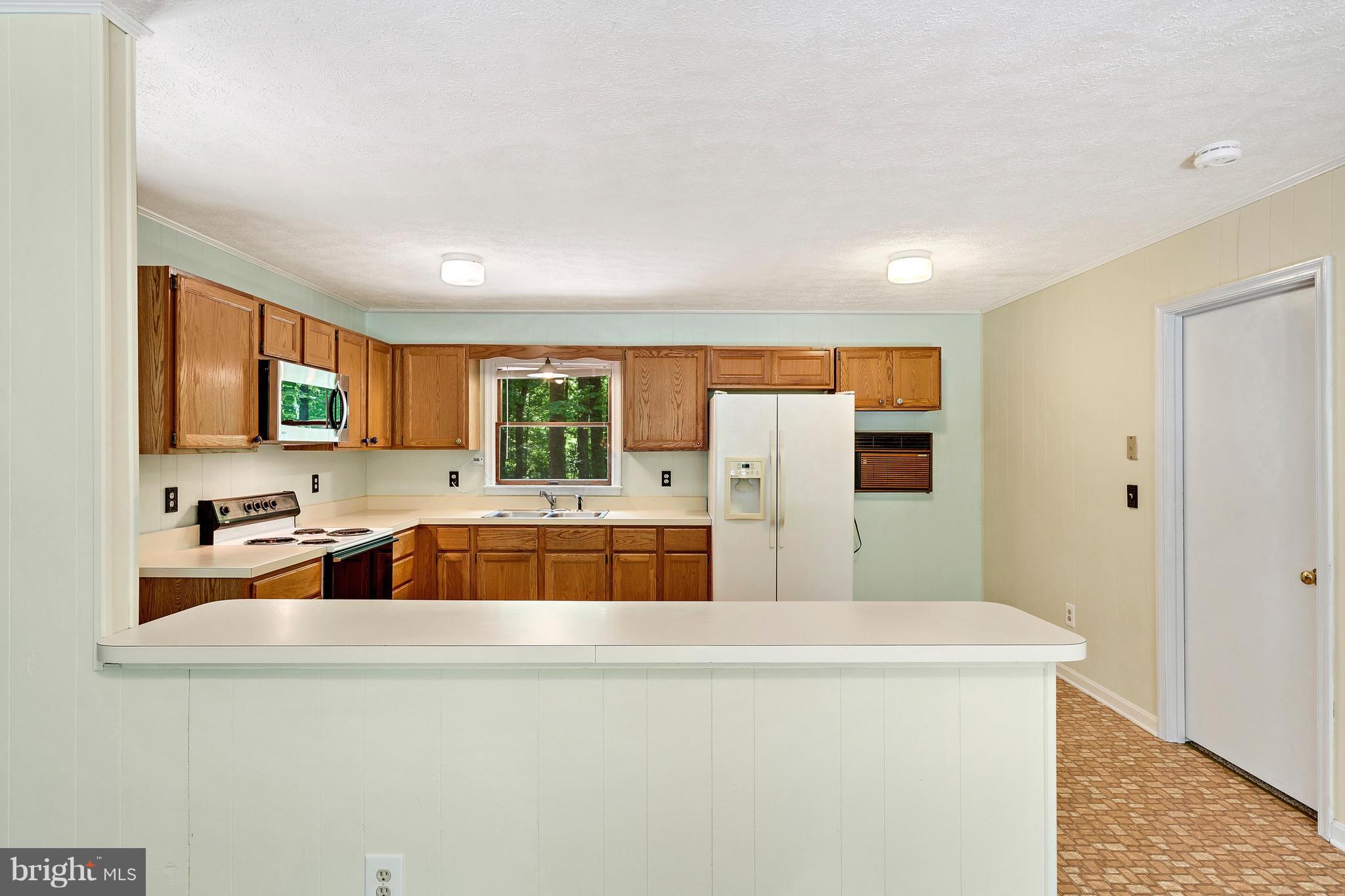 11320 Drogheda Mountain Road Rixeyville, VA 22737 - Photo 7 of 29 a kitchen with refrigerator and cabinets
