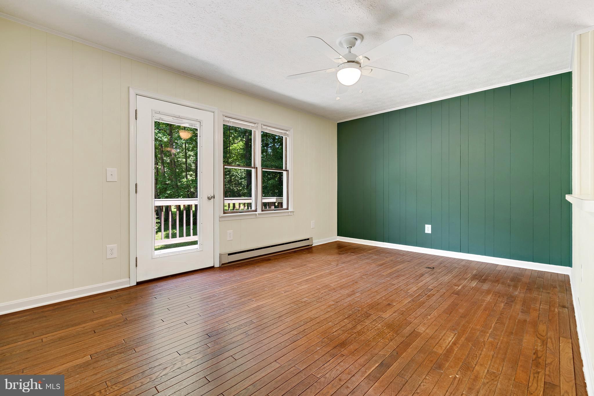 11320 Drogheda Mountain Road Rixeyville, VA 22737 - Photo 9 of 29 a view of an empty room with a window and wooden floor