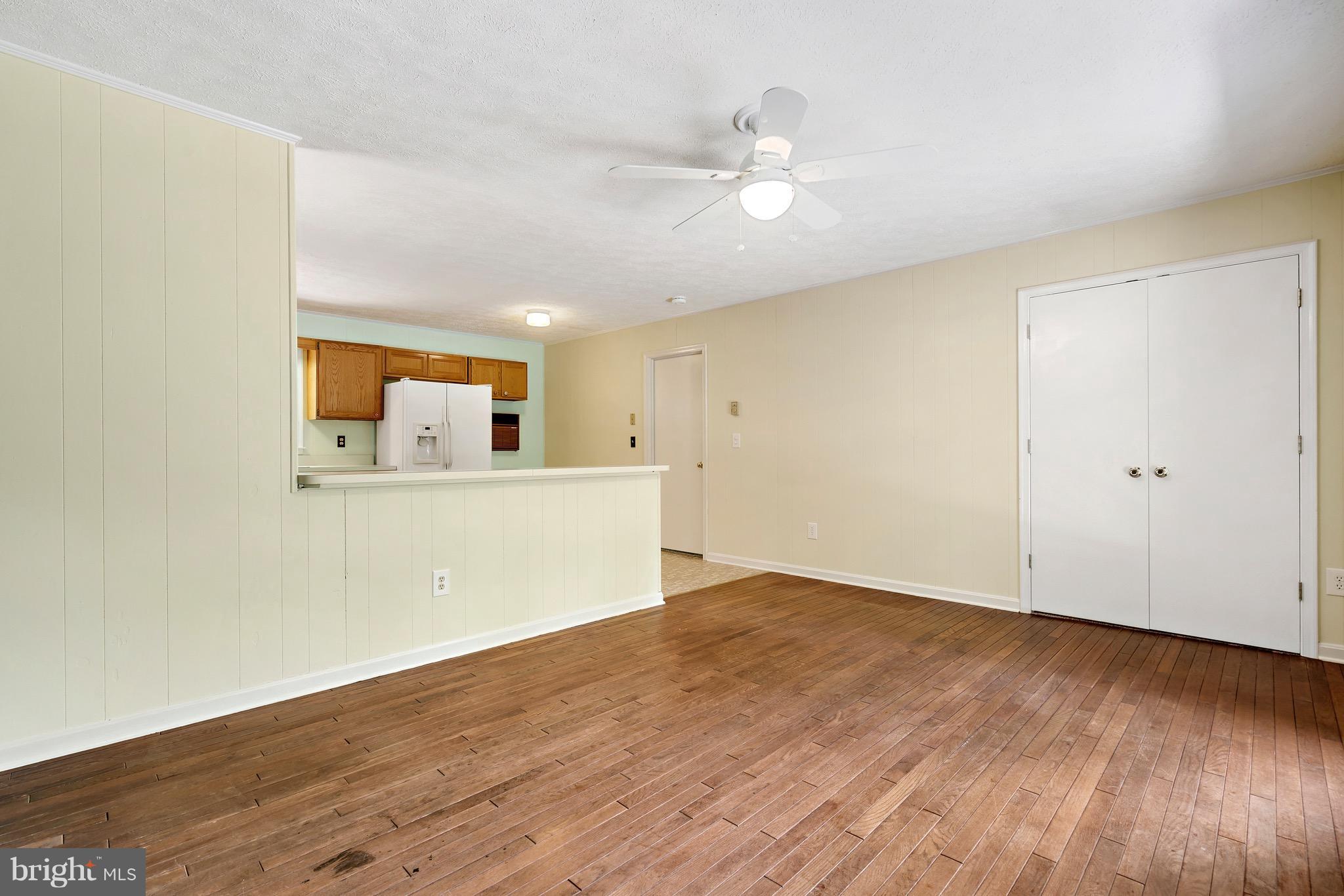 11320 Drogheda Mountain Road Rixeyville, VA 22737 - Photo 10 of 29 an empty room with wooden floor and mirror