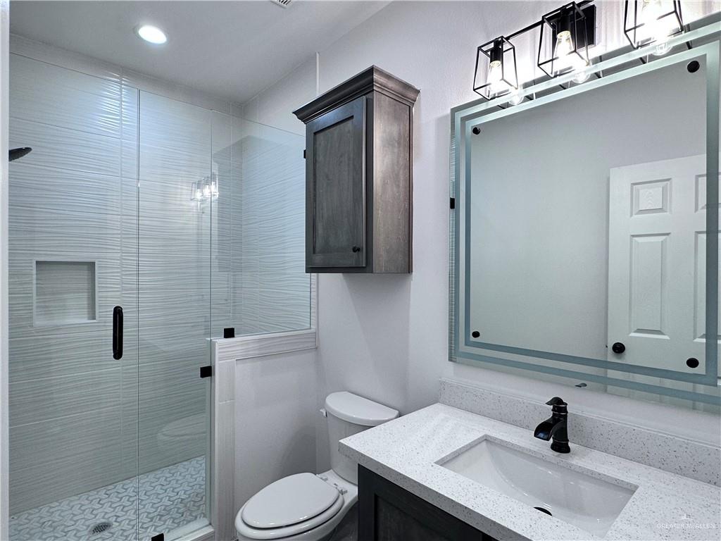 1100 Azalea Street Mission, TX 78573 - Photo 18 of 24 a bathroom with a sink toilet and shower
