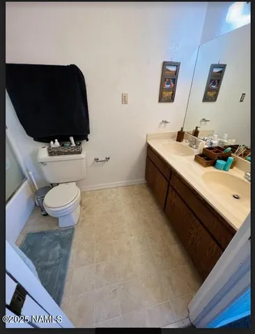 a bathroom with a sink mirror vanity and toilet