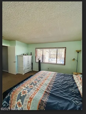 a bed sitting in a bedroom next to a window