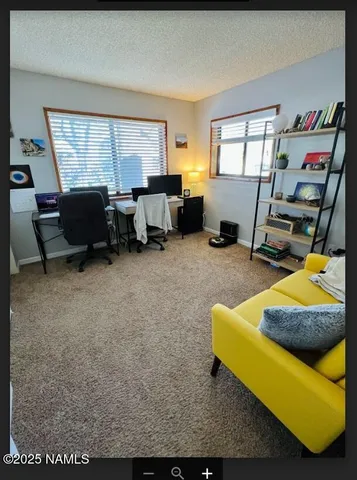 a living room with furniture gym equipment and a large window