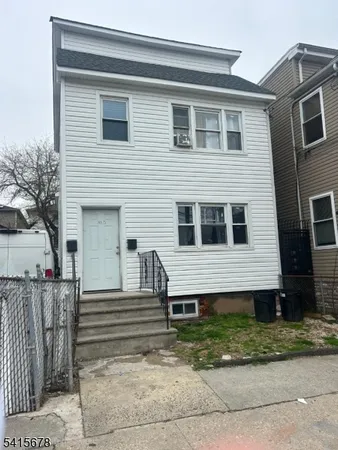 a view of a house with a fence in the background