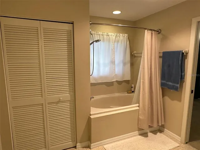 a bathroom with a shower and a bath tub