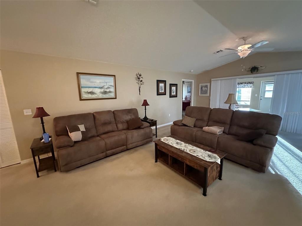 32905 Timberwood Drive Leesburg, FL 34748 - Photo 3 of 27 a living room with furniture and a painting