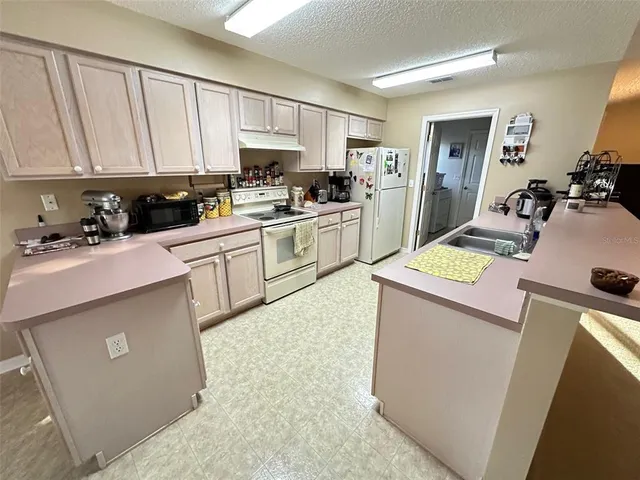 a kitchen with a sink stove and cabinets