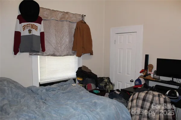 a bedroom with a bed and a flat tv screen