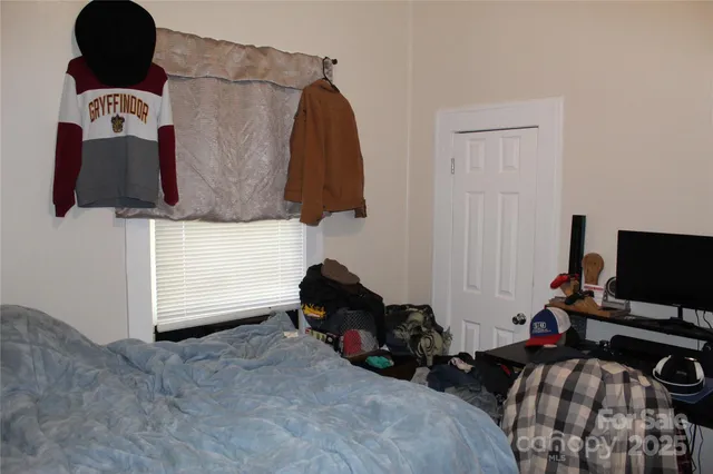 a bedroom with a bed and a flat tv screen