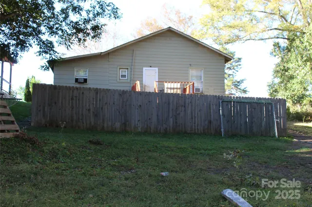 a view of a backyard with wooden fence