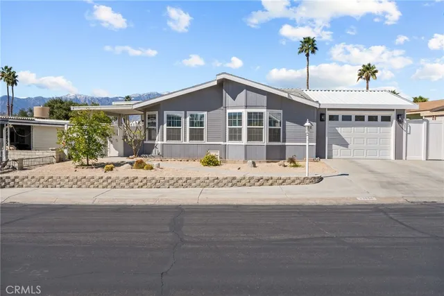 a view of a house with a wooden fence