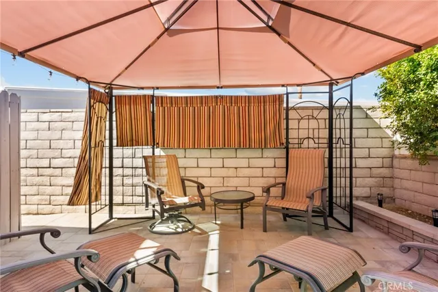 a view of an outdoor sitting area with furniture and umbrella
