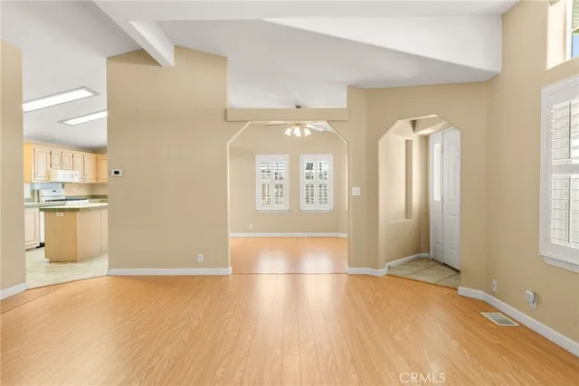 a kitchen with a sink window and cabinets