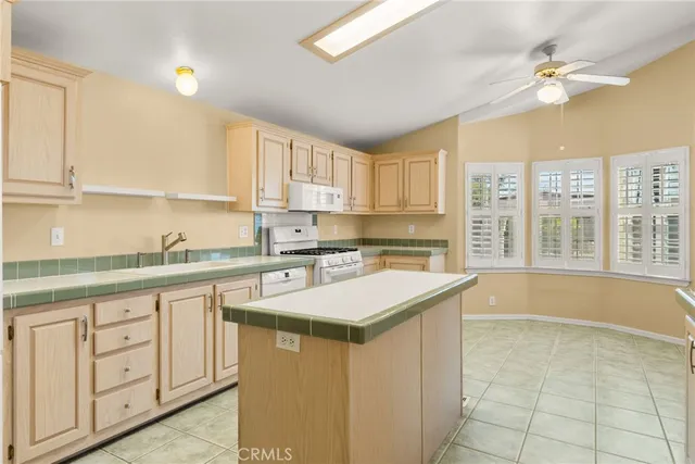 a white stove top oven sitting inside of a kitchen