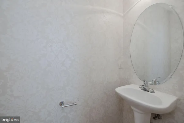 a bathroom with a sink a mirror and toilet