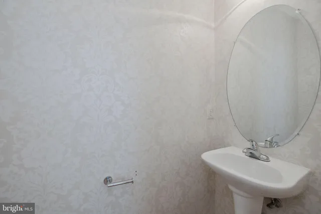 a bathroom with a sink a mirror and toilet