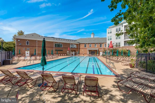 a wooden bench sitting in front of a building