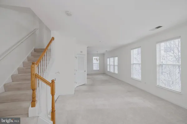 a view of an empty room with stairs