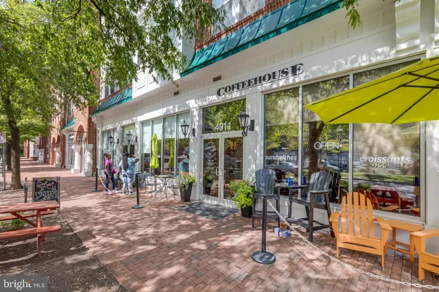 a view of a dinning tables and chairs in backyard of the house