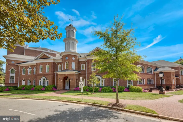 a front view of a building with a garden