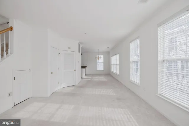 a view of a big room with windows and chandelier