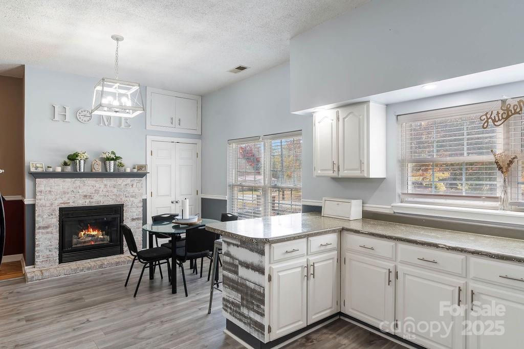 203 Providence Church Road Forest City, NC 28043 - Photo 12 of 46 a kitchen with granite countertop a stove a oven a dining table and chairs with wooden floor