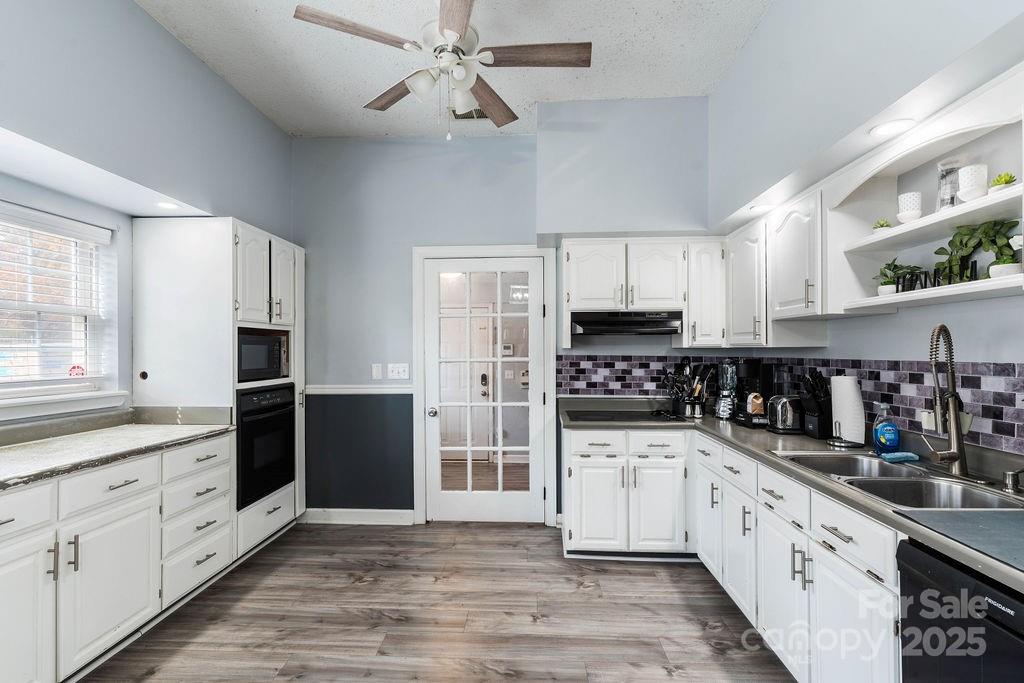 203 Providence Church Road Forest City, NC 28043 - Photo 13 of 46 a large kitchen with stainless steel appliances and white cabinets